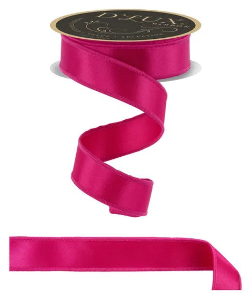 a pink satin ribbon with a gold label, and a plain pink ribbon.
