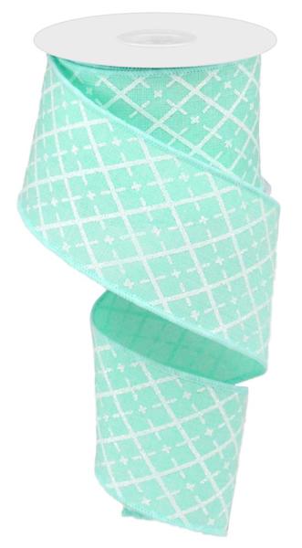 a roll of green ribbon with white squares on it