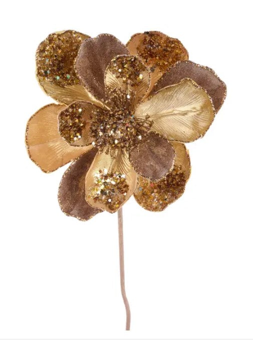 A gold-colored flower with brown and gold accents, including glitter and sparkles, is the main focus of the image.