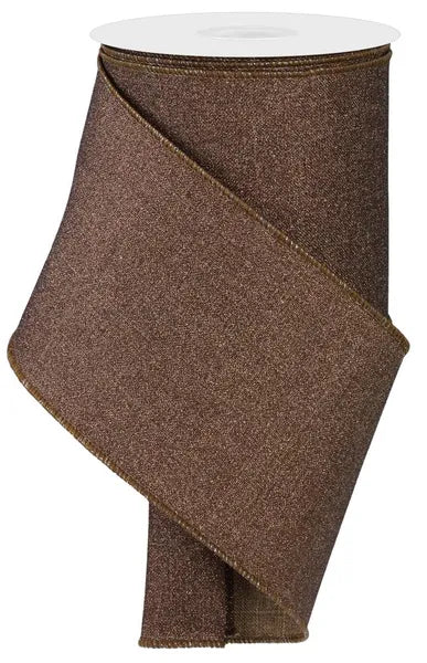 a brown, textured fabric, possibly a ribbon, with a white top.