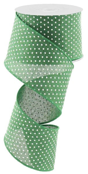 a roll of green polka dot ribbon on a white background