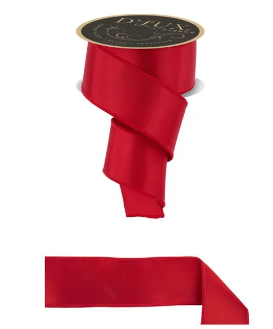 a red satin ribbon with a black label, and a smaller red ribbon below it.