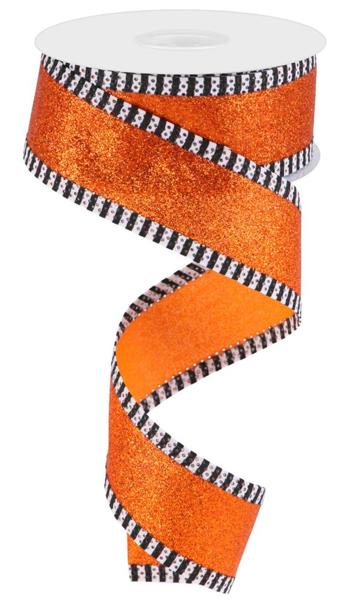 a roll of orange glitter ribbon with black and white stripes