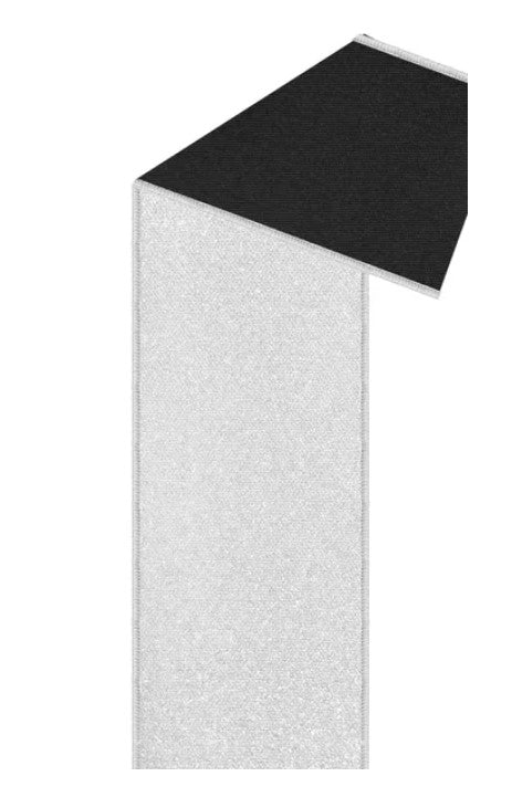 A black and white image depicting a tall, narrow structure with a textured surface.