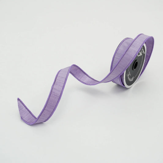 A roll of purple ribbon with a black spool is shown against a white background.