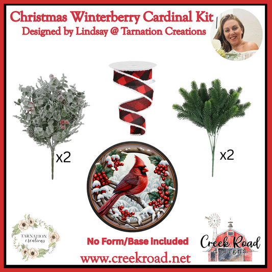 The image is a Christmas Winterberry Cardinal Kit designed by Lindsay @ Tarnation Creations. It includes a Christmas tree, a red and black plaid ribbon, a green pine branch, and a red cardinal bird. The kit is not accompanied by a form or base, and the website www. creekroad.net is provided.