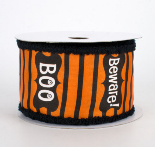 a roll of black and orange ribbon with boo boo on it