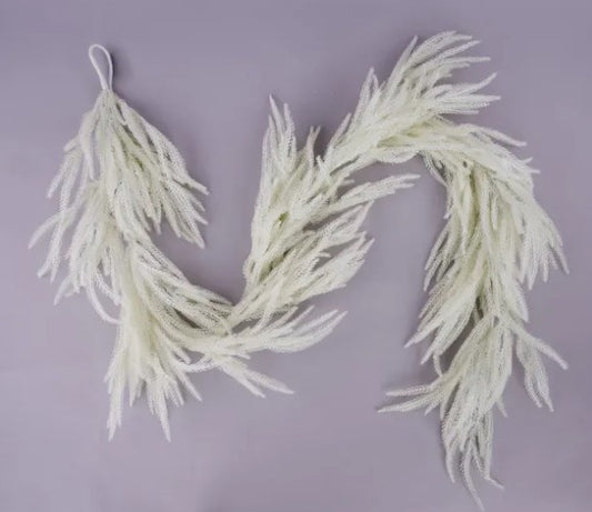 A decorative garland made of white, feather-like strands is displayed against a purple background.