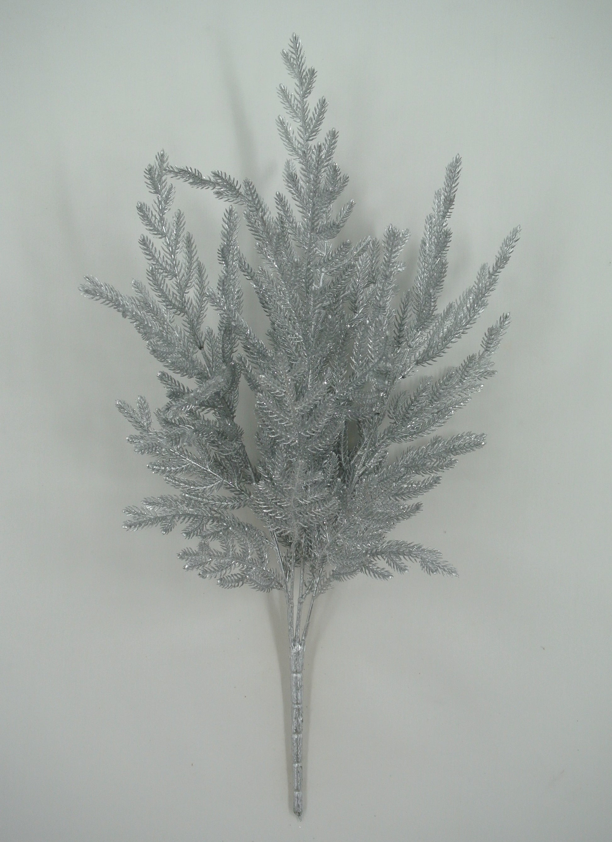 A silver-colored artificial plant or branch with multiple thin, pointed leaves arranged in a cluster.