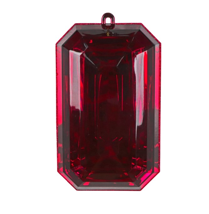 A large, red, rectangular gemstone or crystal is displayed against a white background.