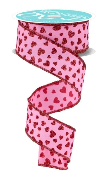 A pink ribbon with a heart pattern is shown, with the ribbon appearing to be made of a shiny material.