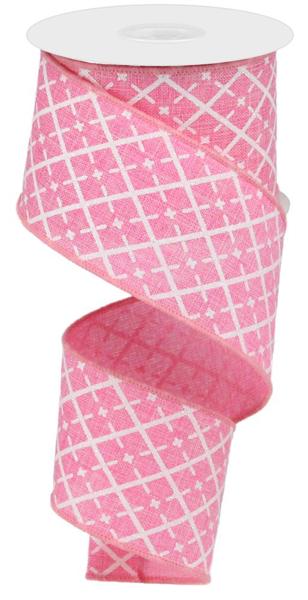 a roll of pink and white patterned ribbon