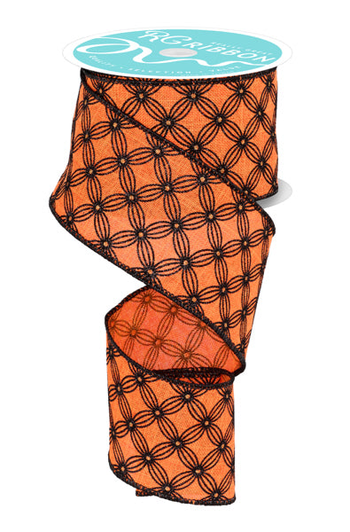 a spool of orange and black floral patterned ribbon.