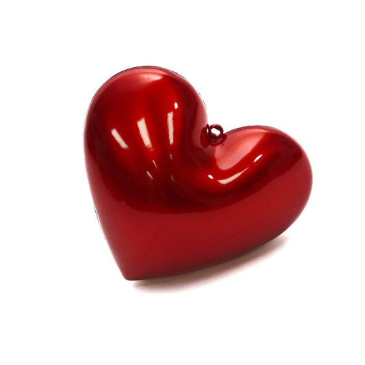 a red heart shaped object on a white background