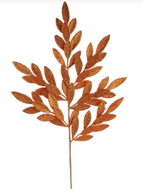 A single, tall, leaf-like object made of a shiny, golden material, resembling a plant or tree branch.