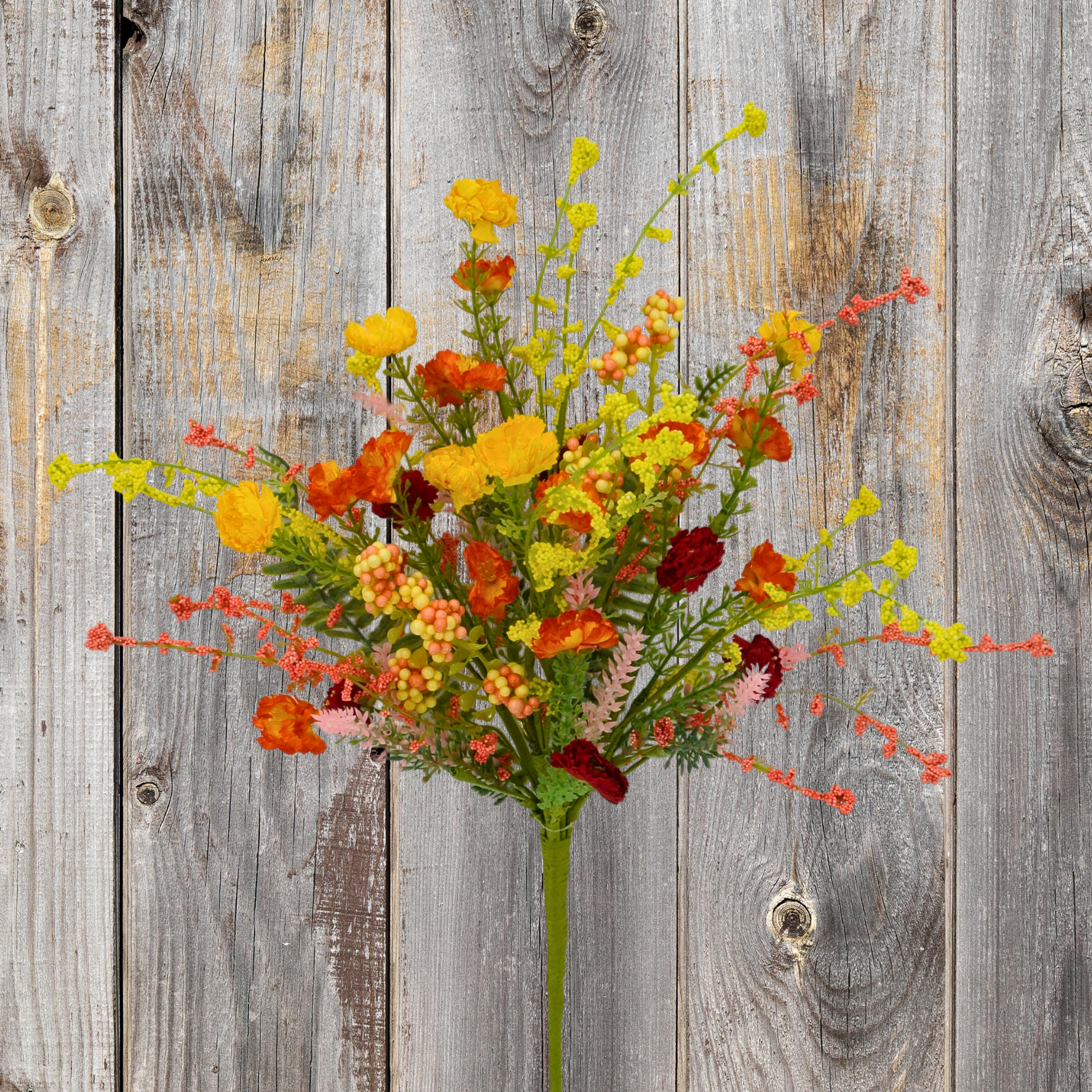 A vibrant bouquet of yellow, orange, and red flowers is displayed against a weathered wooden background.