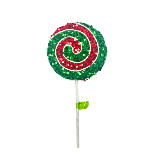 a green and red lollipop on a stick