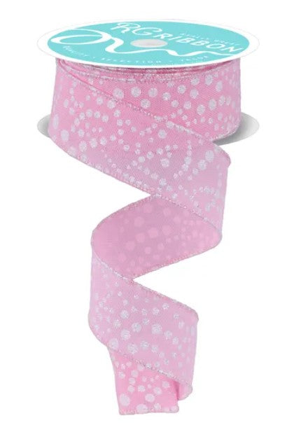 A pink and white polka dot ribbon is shown, with the ribbon winding around a spool of the same ribbon.