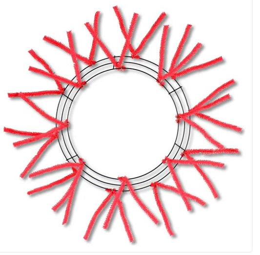 a circular wreath made of red pipe cleaners arranged in a circular pattern.