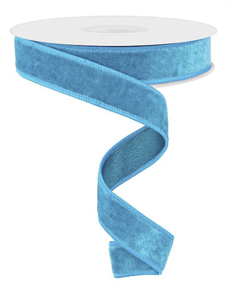 A roll of blue velvet ribbon with a swirled pattern.