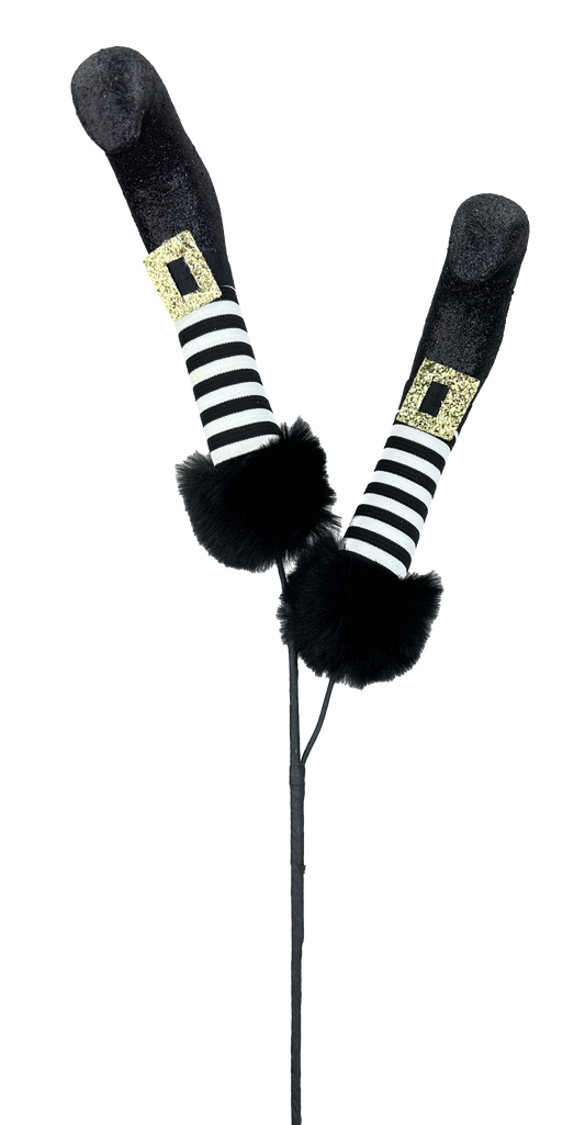 A pair of black and white striped witch's legs with gold buckles, standing on a black pole.