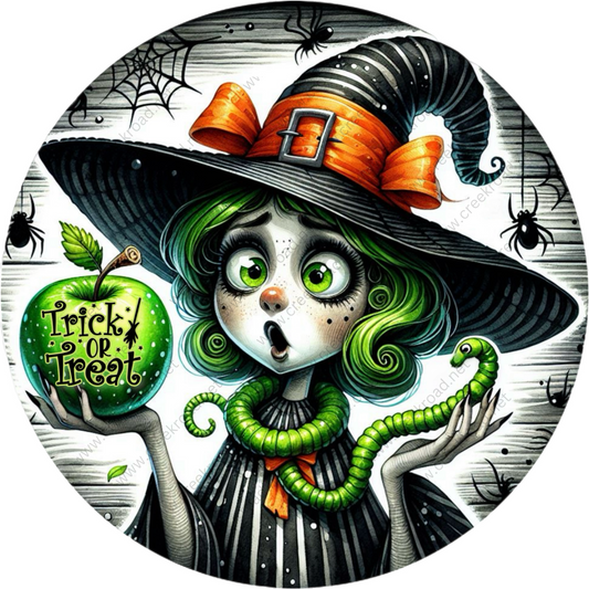 a cartoon of a witch holding a green apple