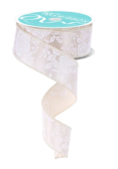 A roll of white floral-patterned ribbon with a turquoise label.