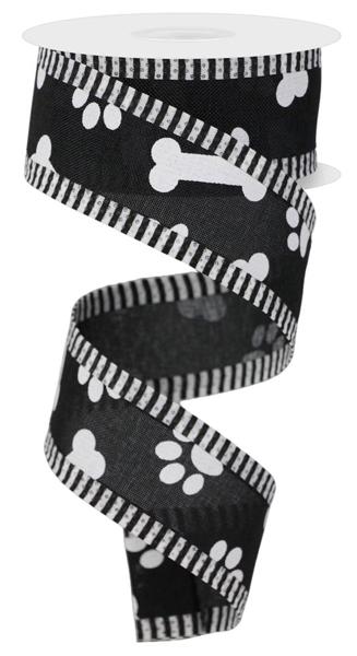 a roll of black and white dog paw and bone ribbon