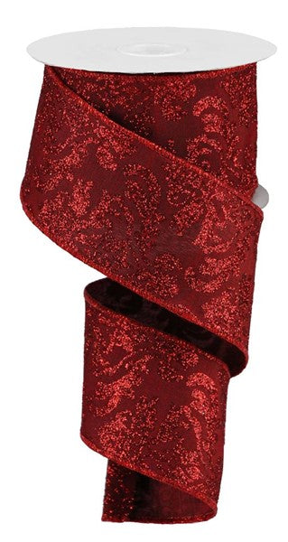 a roll of red glitter ribbon on a white background