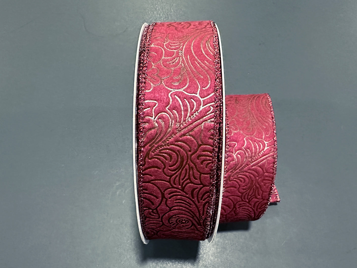 a pair of pink leather bracelets on a gray surface