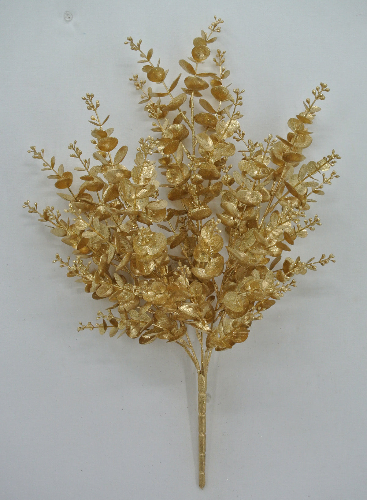 a golden floral arrangement with numerous small leaves and branches, creating a visually striking and elegant display.