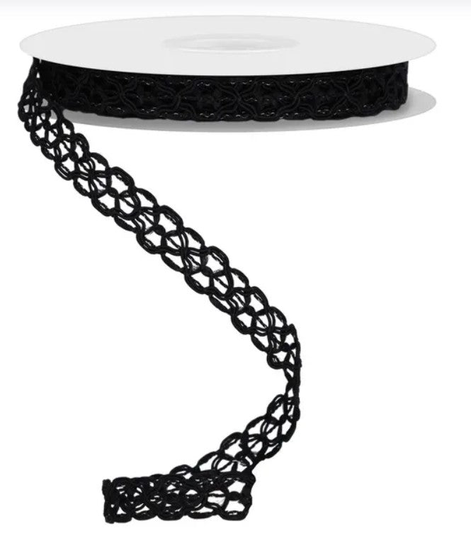 a spool of black lace ribbon with a twisted, braided pattern.