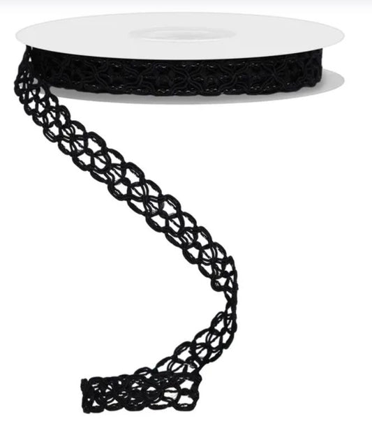 a spool of black lace ribbon with a twisted, braided pattern.