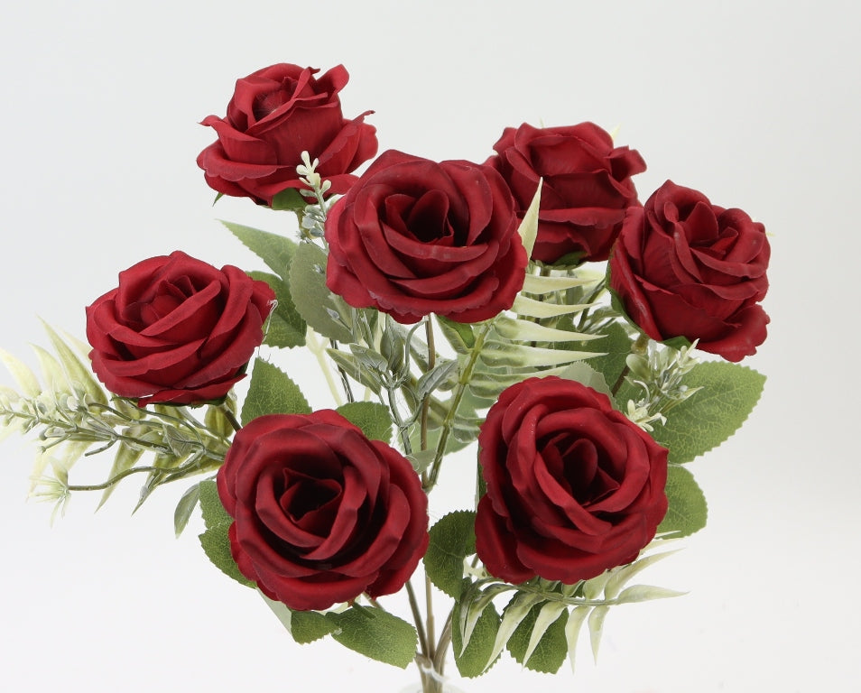 A bouquet of vibrant red roses with green leaves, arranged in a visually appealing manner.