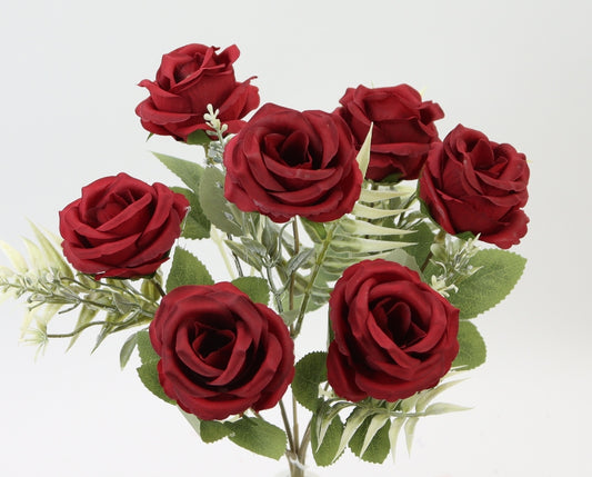 A bouquet of vibrant red roses with green leaves, arranged in a visually appealing manner.
