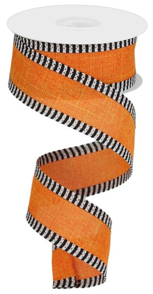 a roll of orange ribbon with black and white stripes