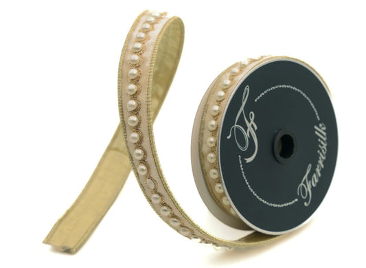 A gold-colored ribbon with a decorative beaded pattern and a black spool of ribbon with the text "Farrilills" printed on it.