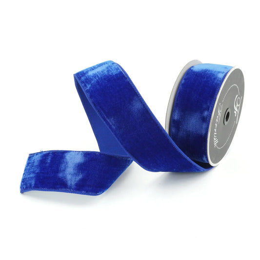 A roll of blue velvet ribbon is shown against a white background.