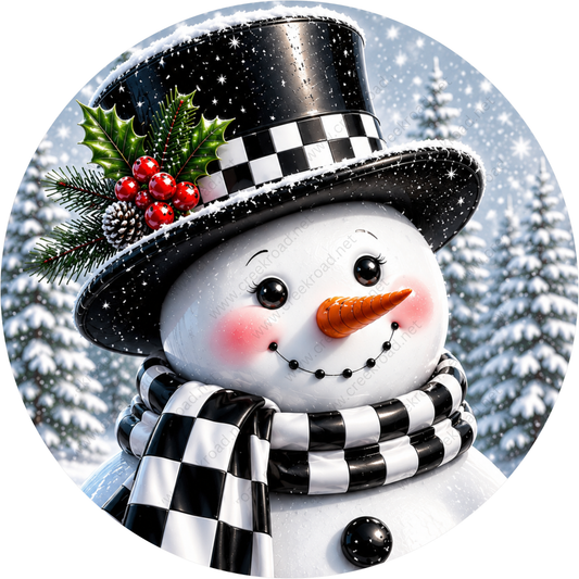 A cheerful snowman with a black and white top hat, a red and green holly leaf, and a black and white scarf, standing in a snowy winter landscape with pine trees in the background.