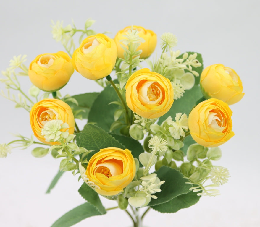 a vase filled with yellow flowers on top of a table