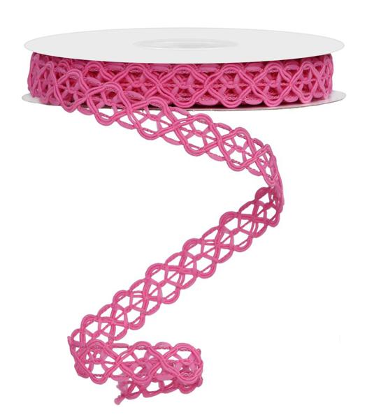 a roll of pink ribbon on a white surface