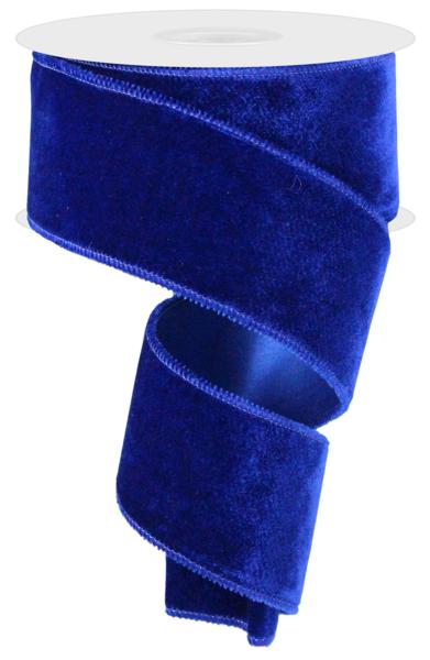 a roll of blue velvet ribbon on a white background