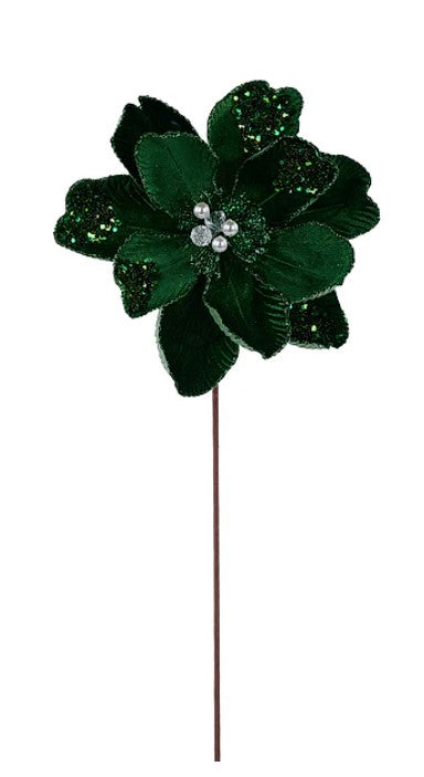 A green, glittery flower with a brown stem is the main focus of the image.