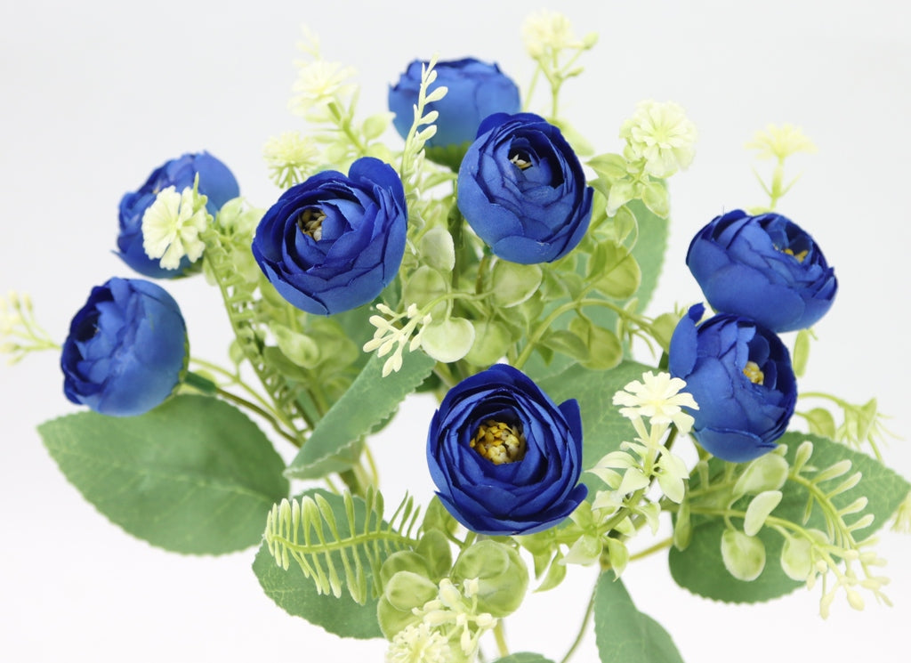 a bouquet of blue flowers with green leaves