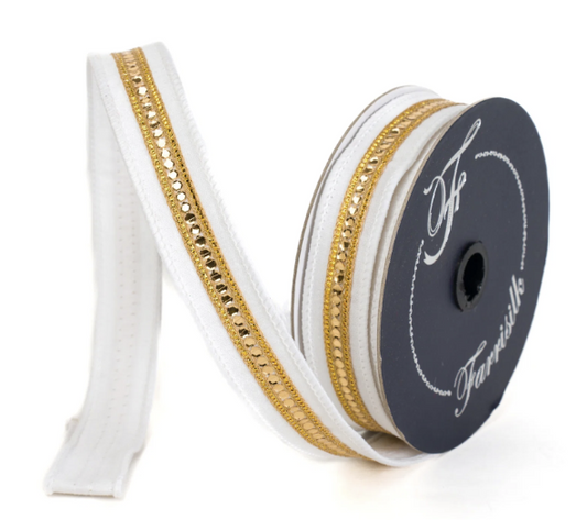 A spool of white and gold ribbon with a decorative gold trim, sitting on a white background.