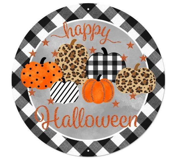 A round metal sign with a checkered border and a black and white pattern. The sign features a group of leopard print pumpkins and a text that says "Happy Halloween".