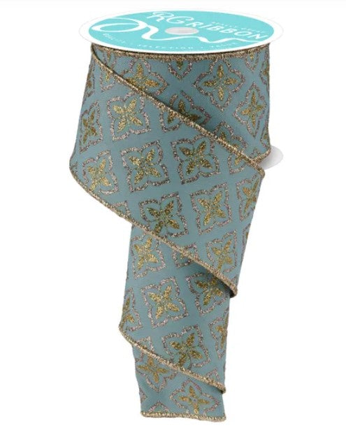 A turquoise and gold patterned ribbon with a white label on top.