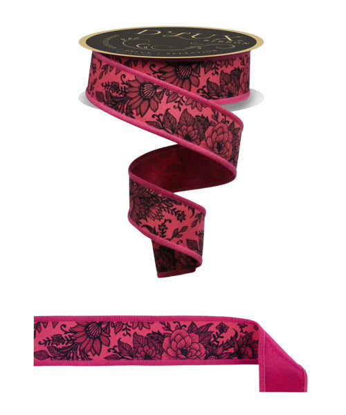a pink floral patterned ribbon with black floral designs, and a black and gold label on top of the ribbon.