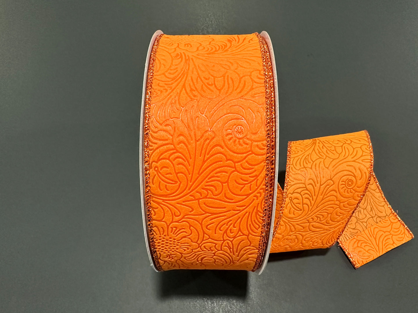 a roll of orange leather with a matching pair of scissors