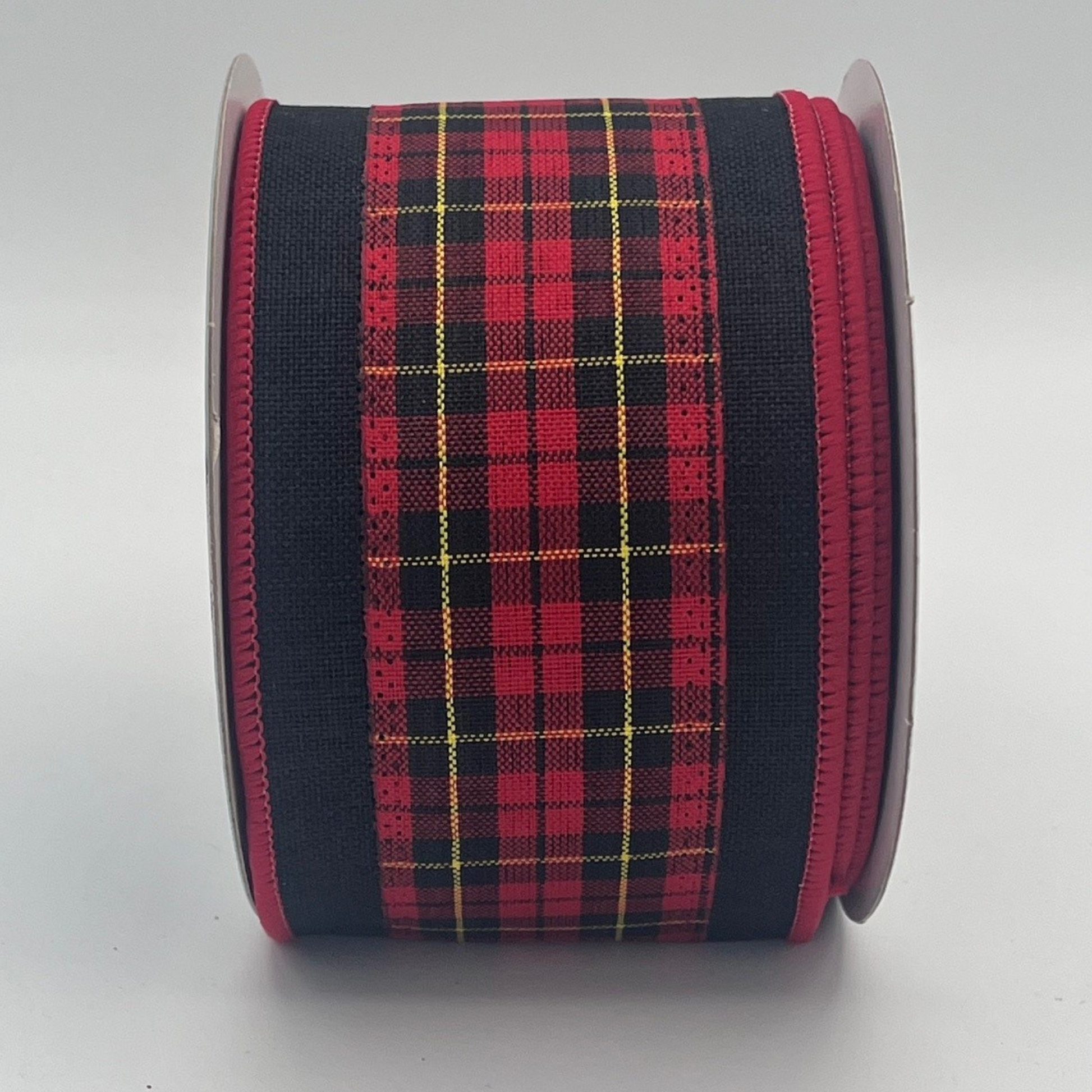 A spool of red and black plaid ribbon with a black border.